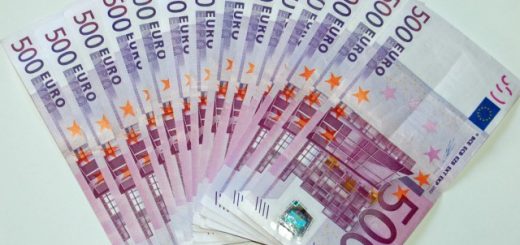 A fanned-out stack of 500 euro banknotes on a white surface.
