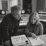 An experienced voice actor and a voice coach going over a script in a studio control room © The Voice Realm