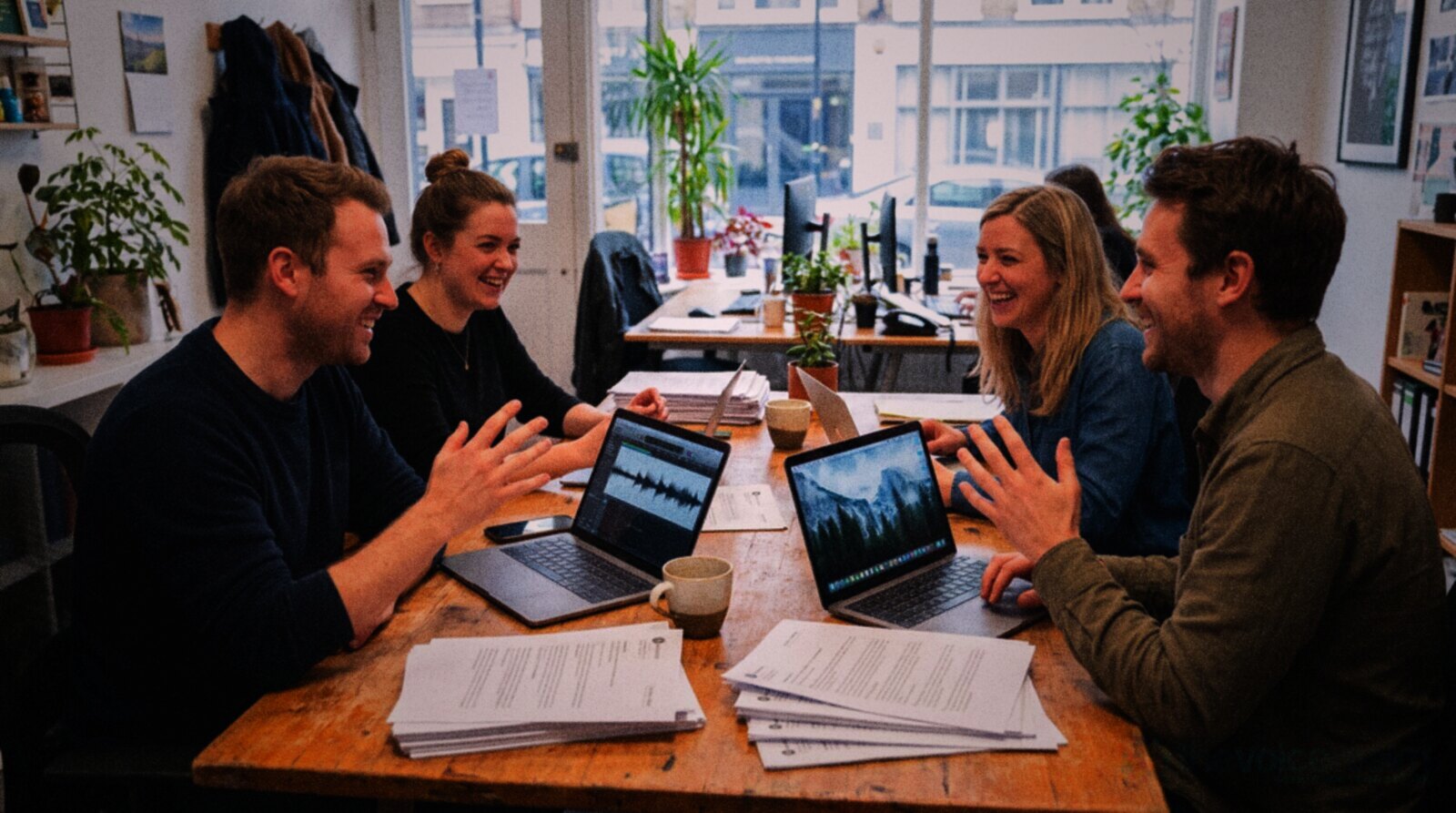 A small team reading survey feedback together around an office table © The Voice Realm