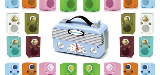 A light blue vintage radio surrounded by a border of colorful small radios on a white background.
