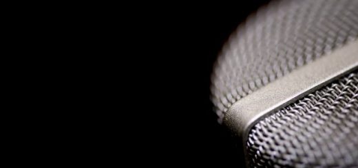Close-up of a wire mesh microphone grille against a black background.
