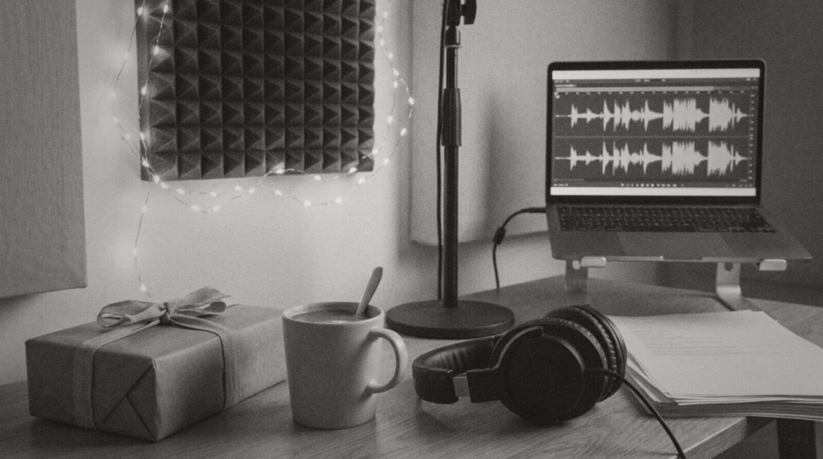 A home voice over studio desk with fairy lights, hot chocolate and a wrapped present © The Voice Realm