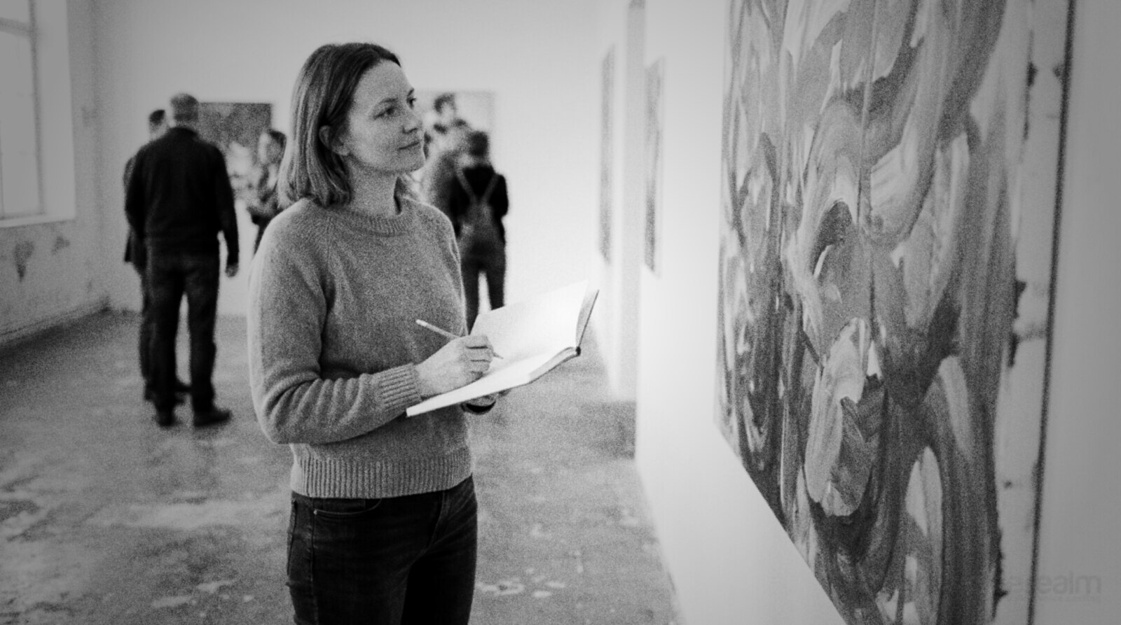 A voice actor finding inspiration in front of a colourful abstract painting in a gallery © The Voice Realm