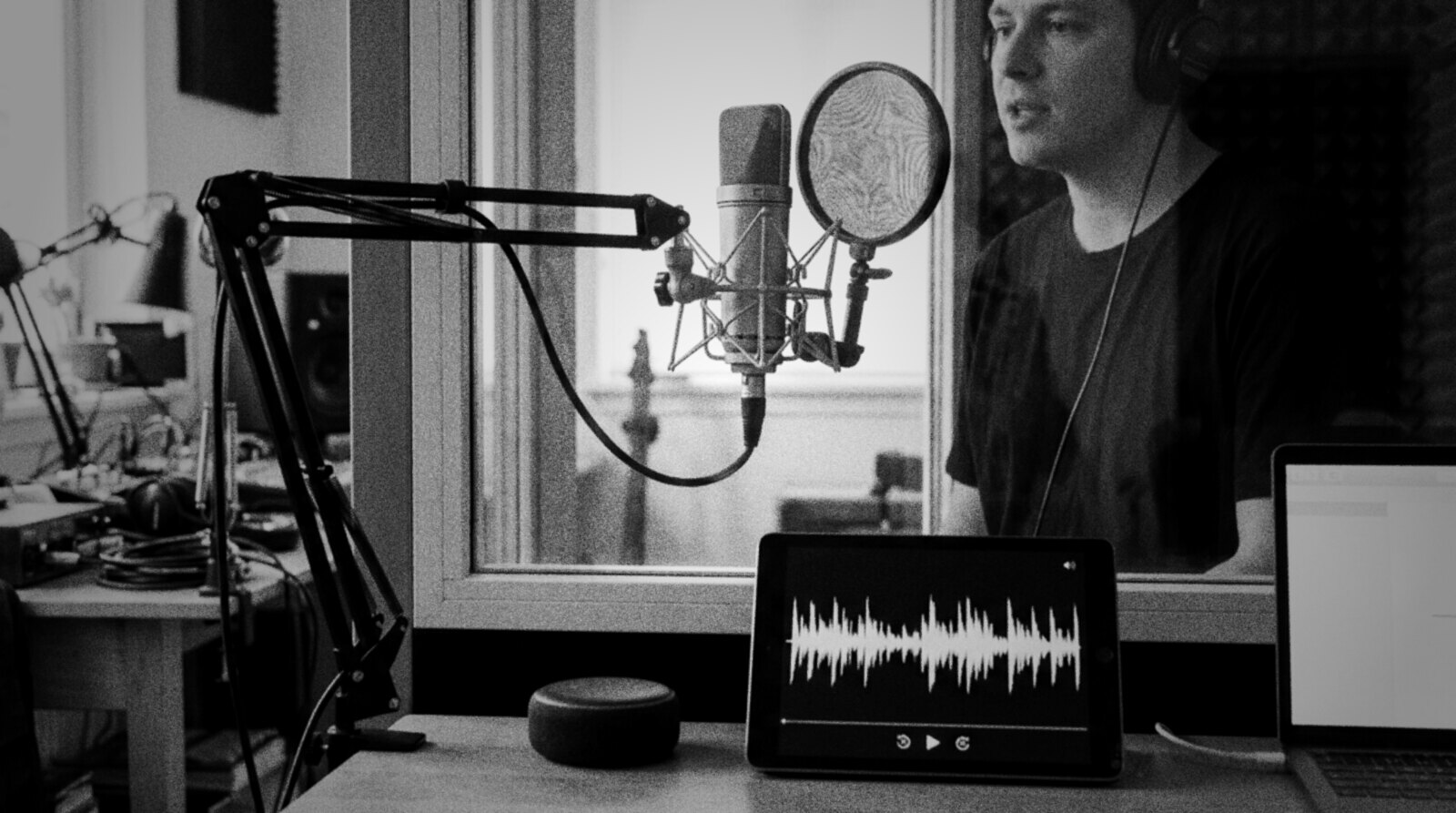A voice actor recording short lines for a smart speaker assistant in a booth © The Voice Realm