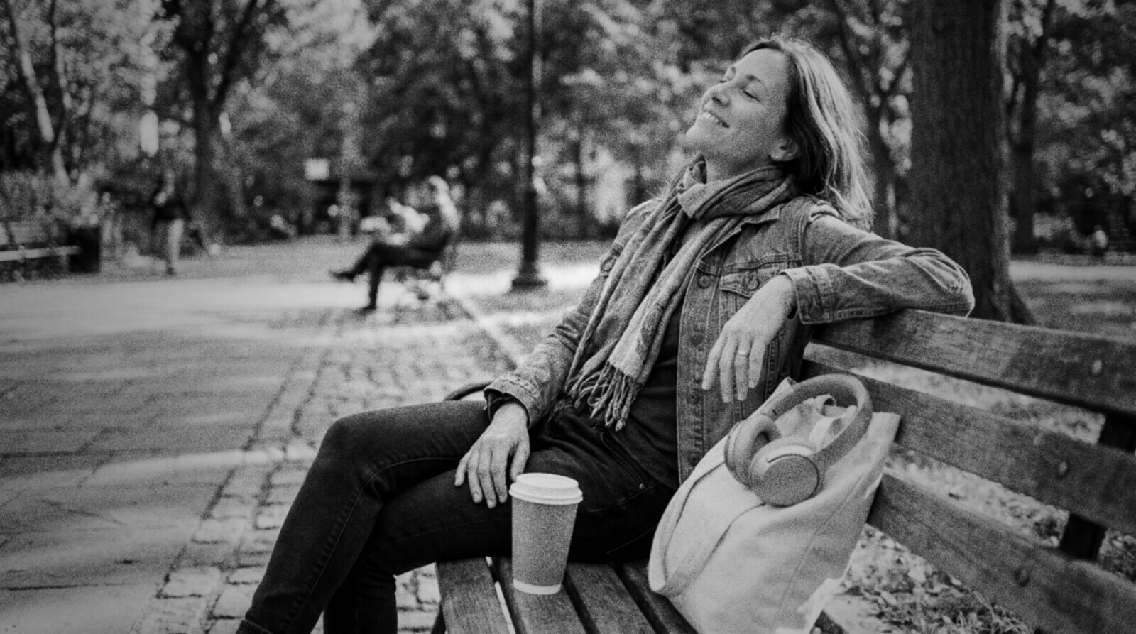A voice actor taking a sunny break on a park bench with a coffee © The Voice Realm