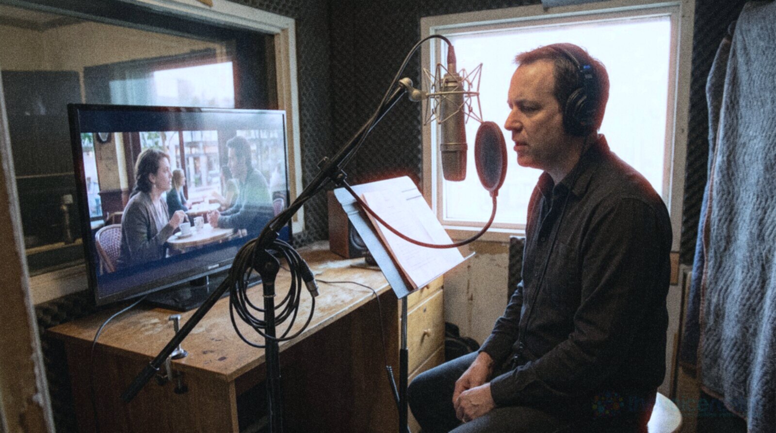 A voice actor dubbing a cafe scene in a recording booth © The Voice Realm