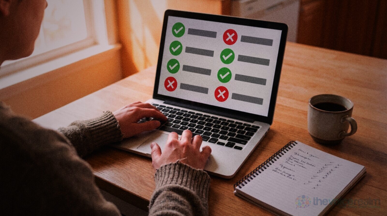 A person at a kitchen table comparing websites on a laptop beside a notebook checklist of ticks and crosses and a mug of coffee © The Voice Realm