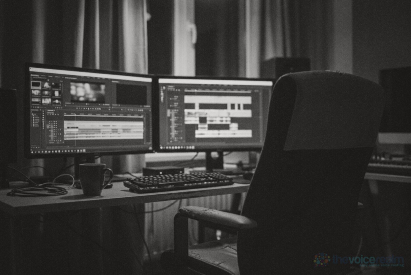 A dark film editing suite at night with two monitors showing a video timeline and audio tracks © The Voice Realm
