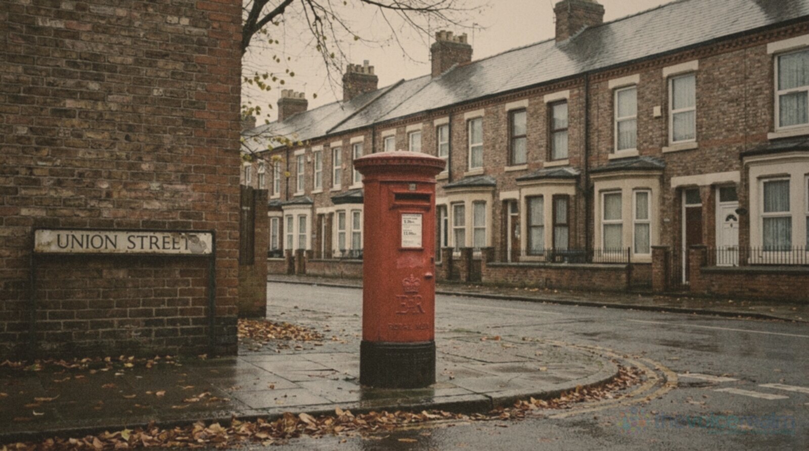 A red pillar post box on a wet street corner beside a Union Street sign, a row of brick terraced houses and fallen leaves behind, in faded seventies print colours © The Voice Realm